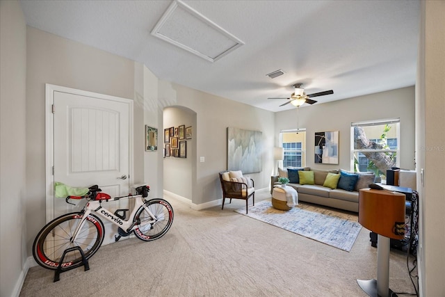 living room featuring light carpet and ceiling fan