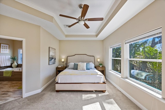 carpeted bedroom featuring ceiling fan and a raised ceiling