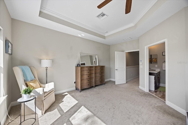 living area featuring ceiling fan, ornamental molding, a tray ceiling, and light carpet