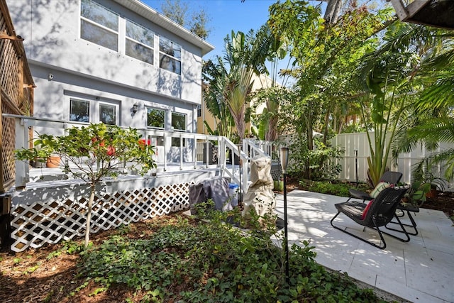 back of property featuring a wooden deck and a patio area