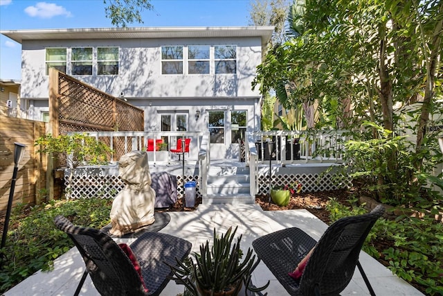 rear view of property featuring a wooden deck