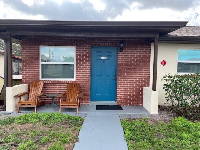 entrance to property with brick siding