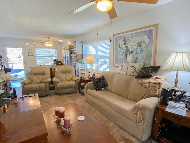 living room featuring carpet flooring, a textured ceiling, and ceiling fan