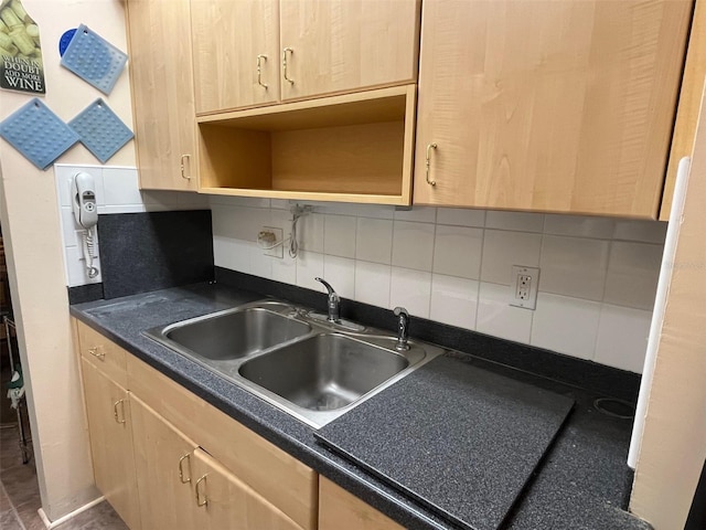 kitchen with open shelves, dark countertops, decorative backsplash, light brown cabinetry, and a sink