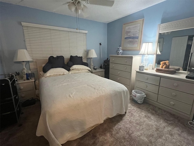 carpeted bedroom with a ceiling fan and a textured ceiling