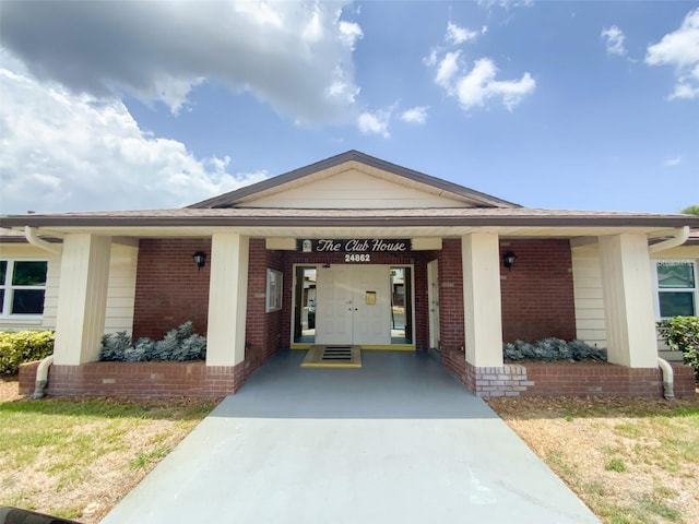 view of exterior entry featuring brick siding