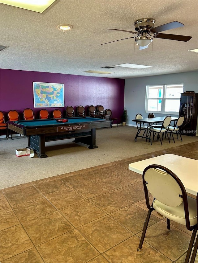 game room featuring a textured ceiling, ceiling fan, and carpet flooring