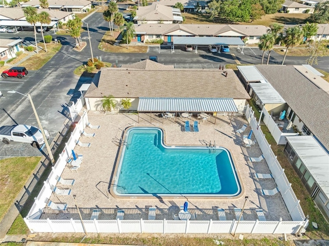 view of swimming pool with fence and a patio