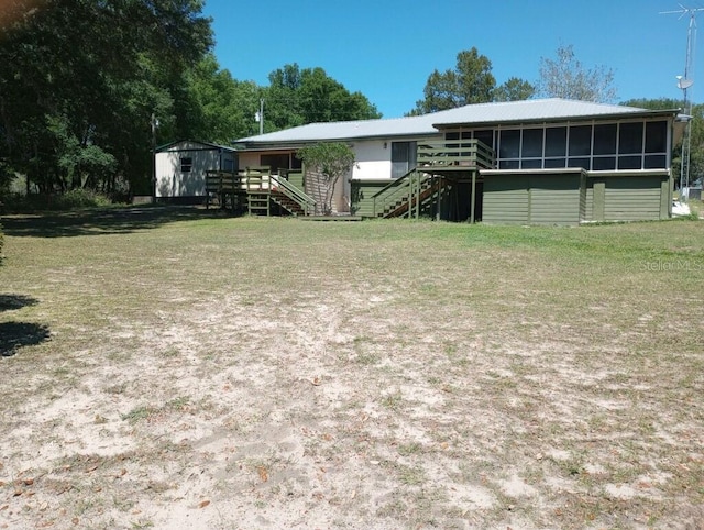 exterior space featuring a sunroom and a front yard