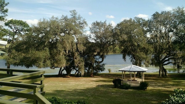 view of property's community featuring a gazebo, a water view, and a yard