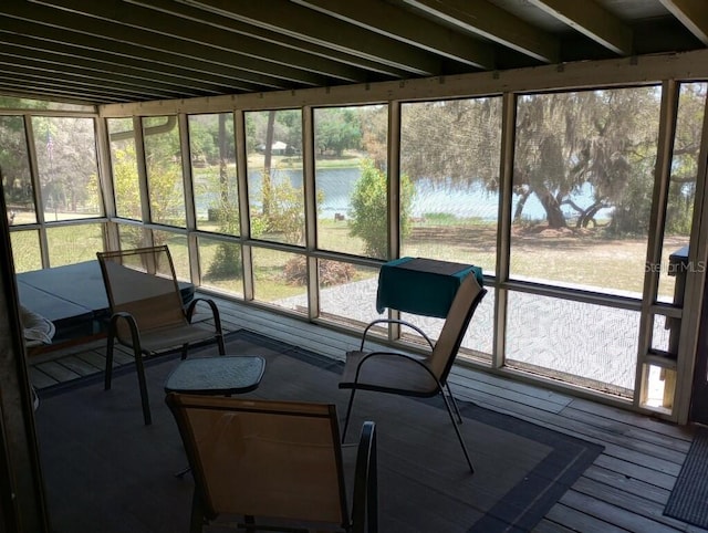 sunroom / solarium with a water view