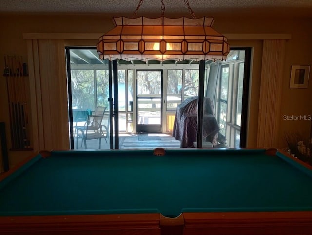 game room featuring pool table and a textured ceiling