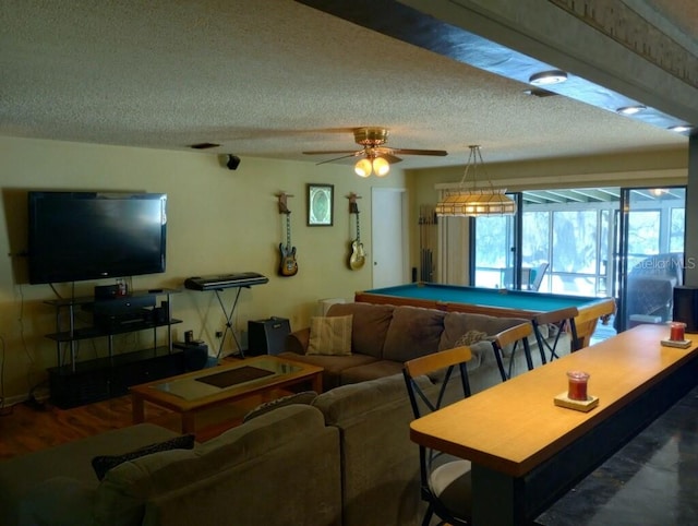 rec room with ceiling fan, hardwood / wood-style flooring, billiards, and a textured ceiling