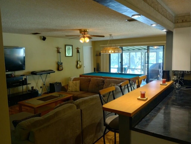 playroom featuring ceiling fan, pool table, and a textured ceiling