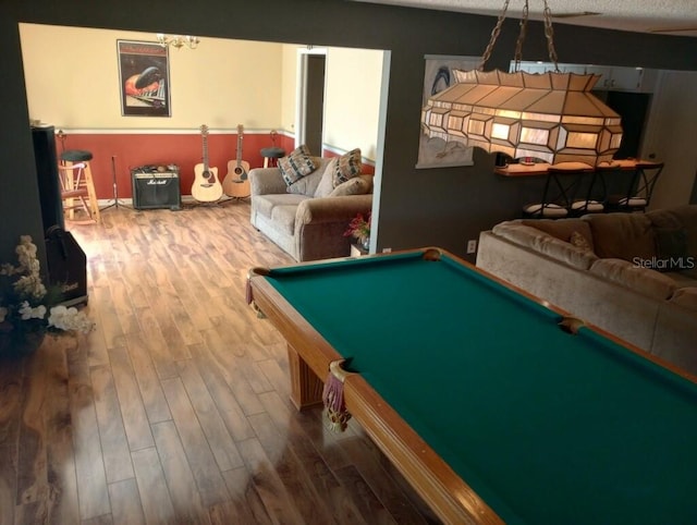 playroom with hardwood / wood-style flooring, pool table, and a textured ceiling