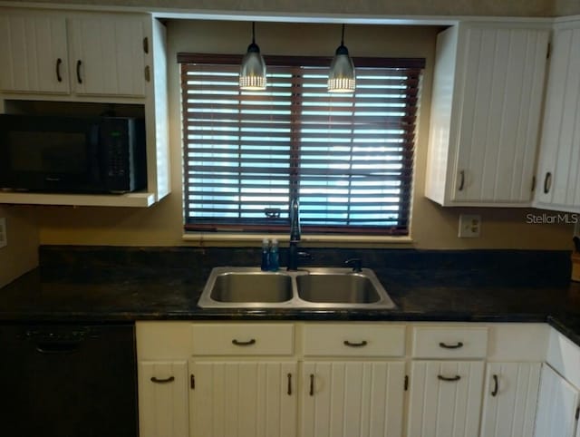 kitchen featuring white cabinets, decorative light fixtures, sink, and black appliances