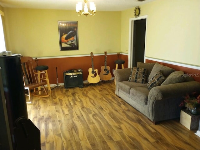 living room with hardwood / wood-style flooring and a notable chandelier