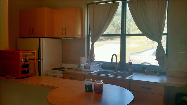 kitchen featuring sink and white appliances