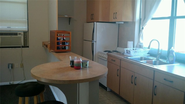 kitchen with sink, cooling unit, white appliances, and light tile patterned floors