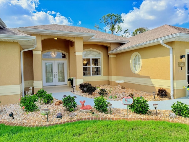 view of exterior entry featuring french doors