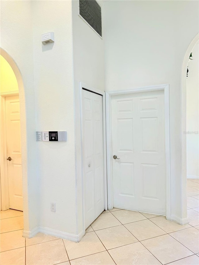 corridor with light tile patterned floors