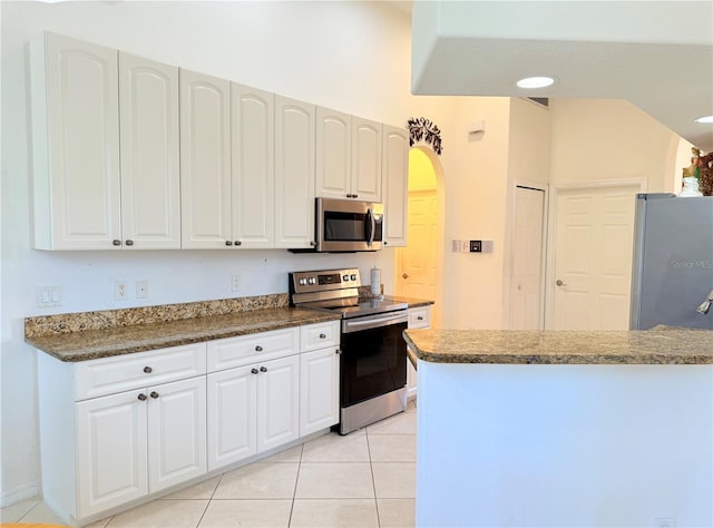 kitchen featuring white cabinetry, appliances with stainless steel finishes, and light tile patterned floors