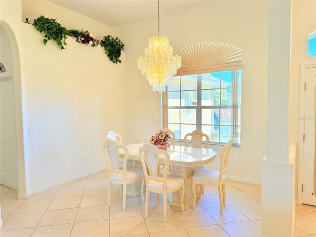 dining room with light tile patterned floors and a chandelier