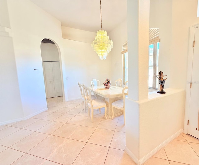 dining room with a chandelier and light tile patterned flooring