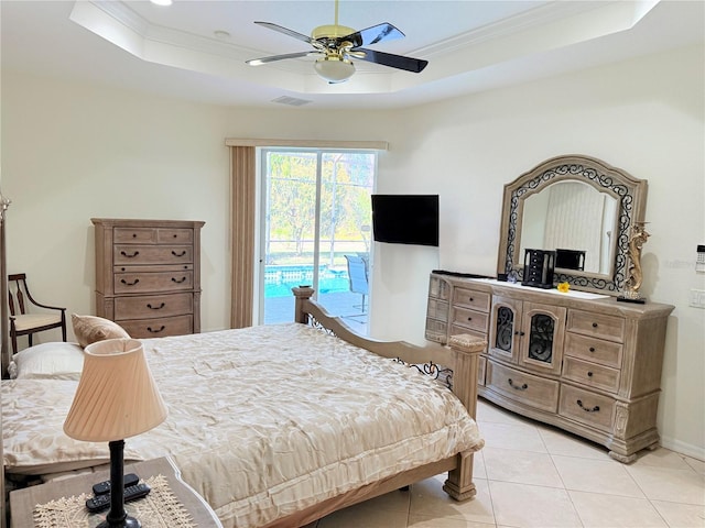 bedroom featuring ornamental molding, light tile patterned flooring, access to exterior, and a tray ceiling