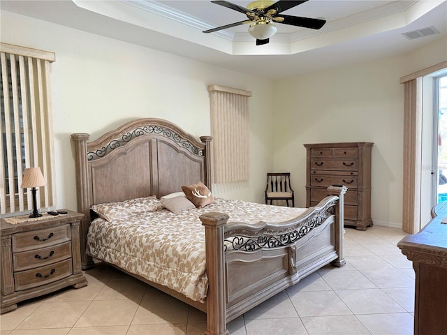 bedroom featuring crown molding, light tile patterned floors, ceiling fan, and a tray ceiling