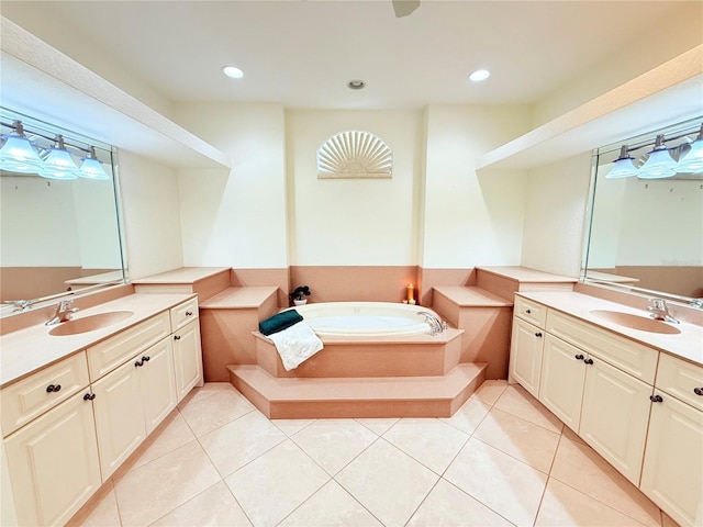 bathroom with tile patterned flooring, vanity, and a bath