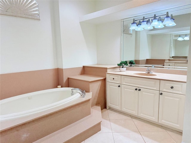 bathroom with tile patterned flooring, tiled tub, and vanity