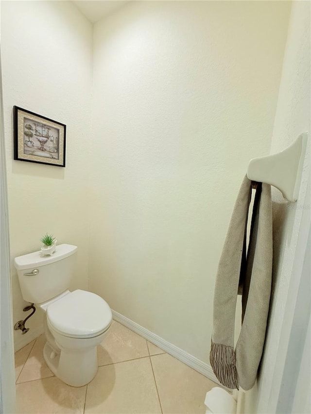 bathroom with tile patterned flooring and toilet