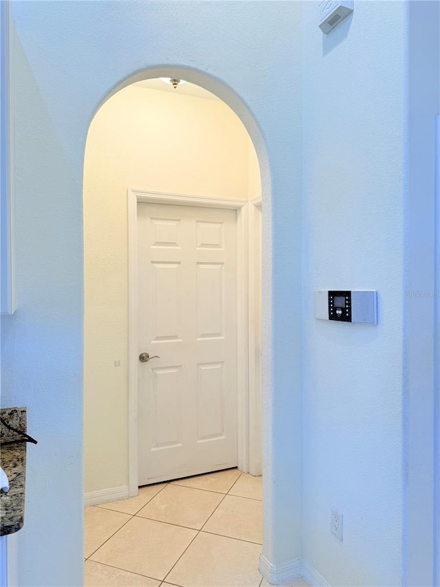 corridor with light tile patterned floors