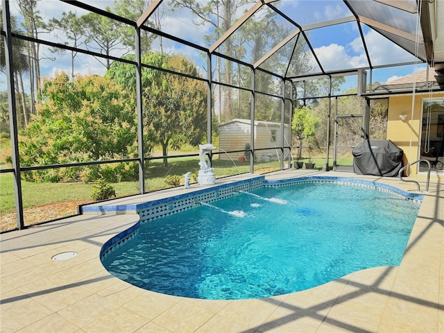 view of swimming pool with a grill, a lanai, a patio area, and a shed