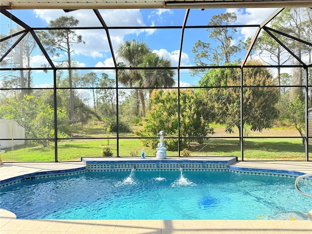 view of pool featuring glass enclosure and a lawn