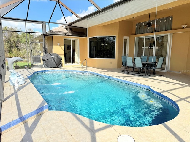 view of pool with a lanai, a grill, ceiling fan, and a patio area