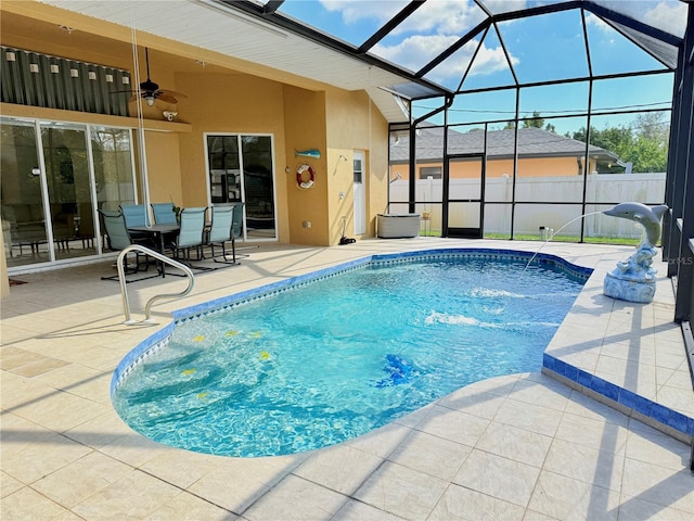 view of pool featuring ceiling fan, a patio area, and glass enclosure