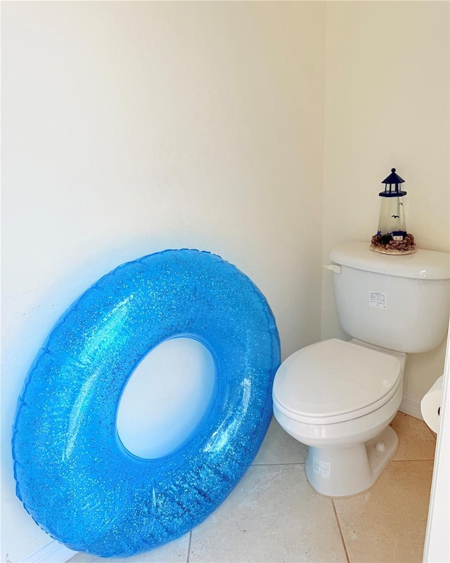 bathroom featuring toilet and tile patterned flooring