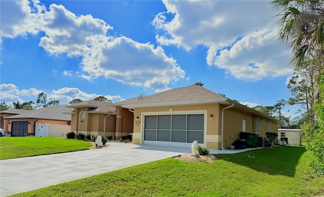 view of front of home featuring a garage and a front lawn