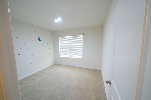 empty room featuring light colored carpet