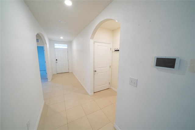 hallway featuring light tile patterned flooring