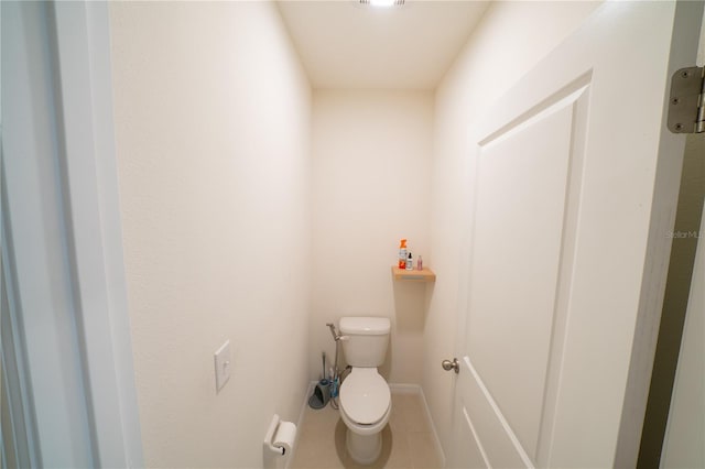 bathroom with tile patterned floors and toilet