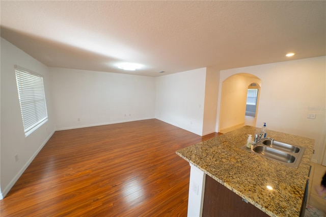 unfurnished living room with sink and dark hardwood / wood-style flooring