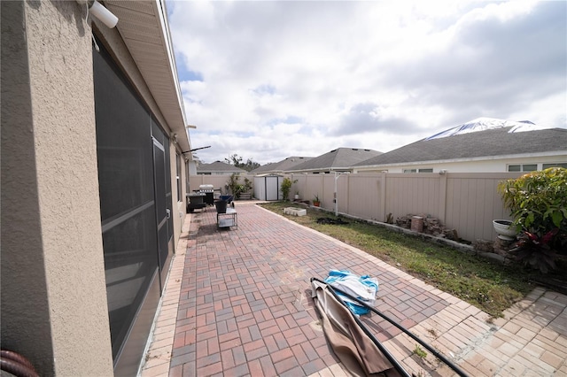 view of patio featuring a storage unit