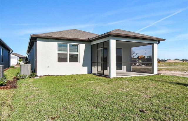 8731 SW 57th Ln, Ocala, FL 34481 - back of house with a sunroom, a yard, and central AC