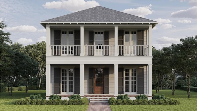 view of front of property featuring a front yard, a balcony, covered porch, and roof with shingles