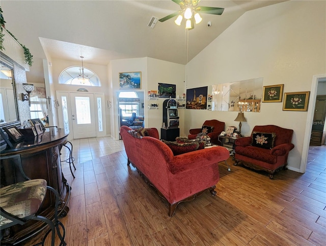 living room with ceiling fan, high vaulted ceiling, and hardwood / wood-style floors