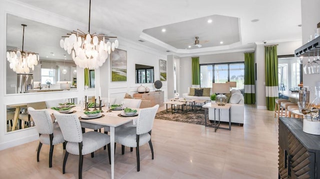 dining area with crown molding, a tray ceiling, and ceiling fan with notable chandelier