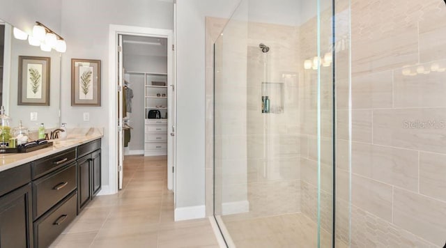 bathroom with tile patterned floors, vanity, and an enclosed shower